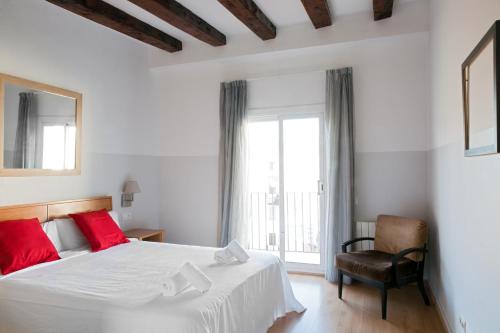 a bedroom with a bed and a chair and a window at My Address in Barcelona Downtown in Barcelona