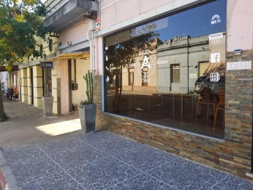 a store window with a reflection of a building at Hotel A Mi Gente in Castillos