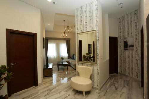 a living room with a mirror and a couch at Marbella Holiday Homes in Dubai