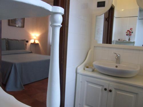 サセッタにあるVilla il Castagnoのバスルーム(シンク、鏡付きベッド1台付)
