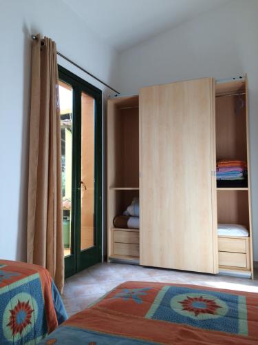 a bedroom with a door open to a closet at Cottage Su Giudeu in Chia
