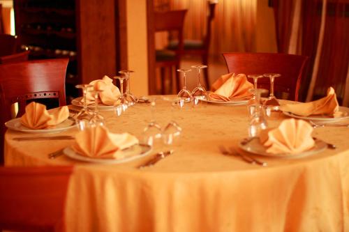 a white table with plates and napkins on it at Hotel Ulisse in Maida