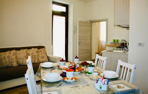 a table with food on it in a living room at B&B La Piccola Corte in Polpenazze del Garda