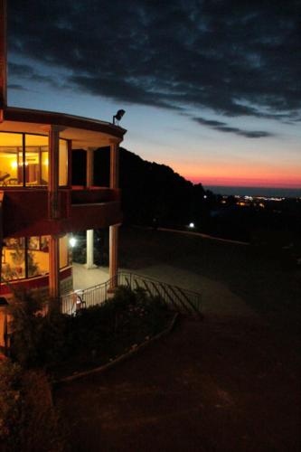 a bird sitting on top of a building at night at Hotel Ulisse in Maida