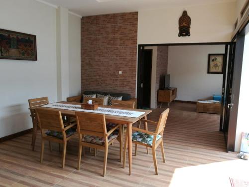 a dining room with a table and chairs at Jogja City Residence in Yogyakarta