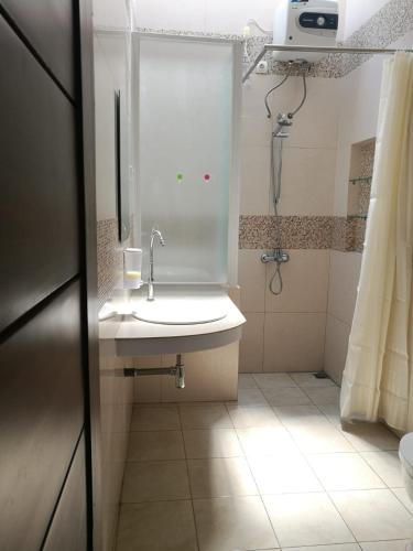 a bathroom with a sink and a shower at Jogja City Residence in Yogyakarta