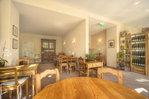 a dining room with wooden tables and chairs at Gästehaus Moselkloster in Trittenheim