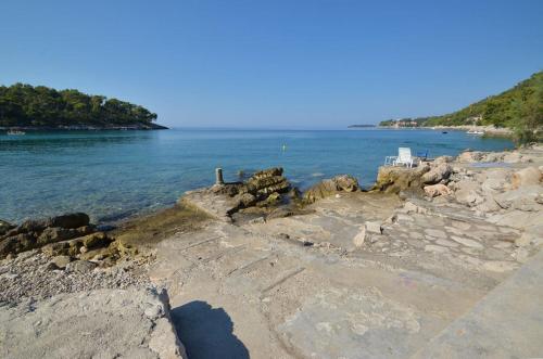 a view of the ocean from a rocky shore at Apartments Prižba Bay in Prizba