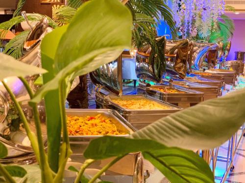 a buffet line with many trays of food at Violet Al Azizia Hotel MASJID Al Qatari in Makkah