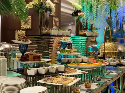 a buffet with many different types of food on display at Violet Al Azizia Hotel MASJID Al Qatari in Makkah