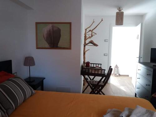 a bedroom with a bed and a table with a desk at La Tana del Ghiro Locazione Turistica in Sedico