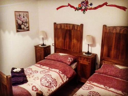a bedroom with two beds and two night stands at La Tana del Ghiro Locazione Turistica in Sedico