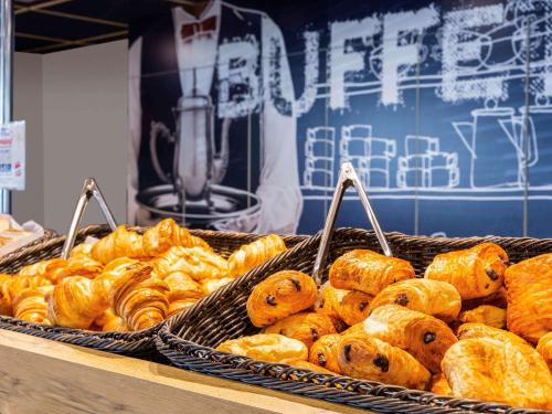 a bunch of pastries on a display in a bakery at ibis budget Paris Porte d'Italie Est in Le Kremlin-Bicêtre
