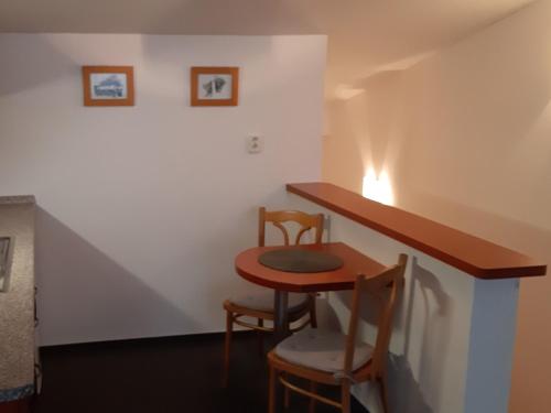 a small room with a table and two chairs at Štúdiá Správa TANAPu in Štrbské Pleso