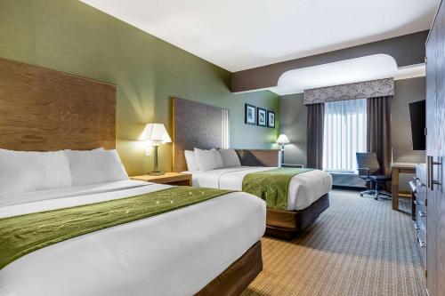 a hotel room with two beds and a desk at Comfort Suites Southgate-Detroit in Southgate