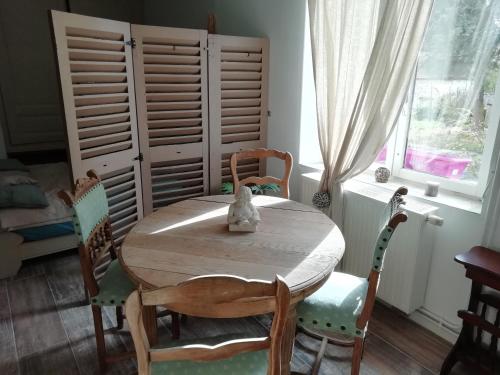 a dining room with a wooden table and chairs at Les Bories en Champagne in Montlevon