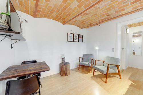 a living room with a wooden table and chairs at Adventure Park Apartments in Ringkøbing