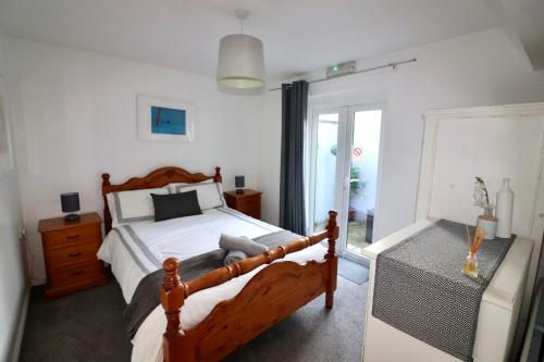a bedroom with a wooden bed and a window at Clifton Park in Belfast