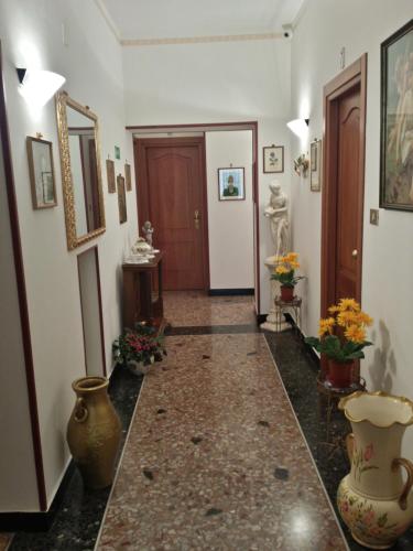 a hallway with vases on the floor of a room at Hotel Triestina in Noli