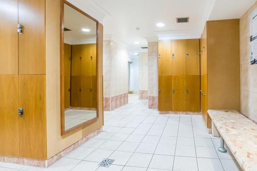 a bathroom with wooden stalls and a mirror at The Aberdeen Altens Hotel in Aberdeen