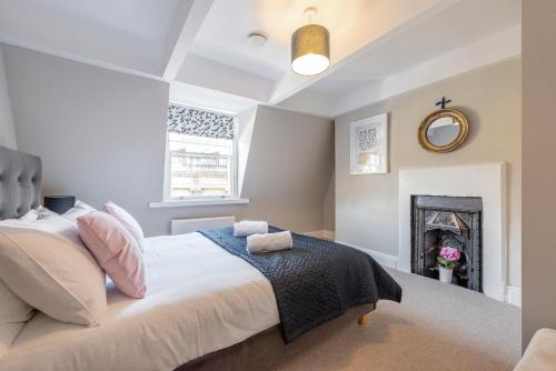 a bedroom with a bed and a fireplace at Stunning & Central Milsom Street Apartment in Bath