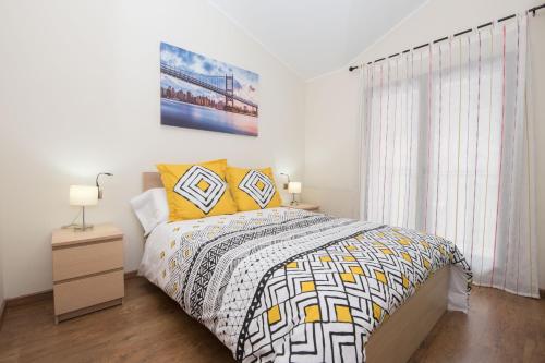 a bedroom with a bed with yellow pillows at Apartamento cerca de Pistas in Bordes d´Envalira