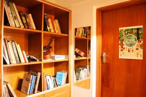 a book shelf filled with books next to a door at BE ANIMAL Hostel in Bangalore