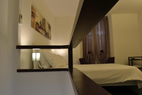 a hotel room with a bed and a mirror at Palazzo Velli Suites in Rome
