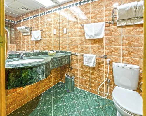 a bathroom with a sink and a toilet at Zain International Hotel in Dubai