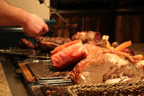 a person is cooking meat on a grill at The Bold Hotel; BW Signature Collection in Southport