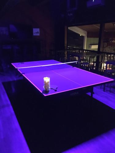 a purple ping pong table with a piece of cake on it at The Iona Heights Inn in Iona