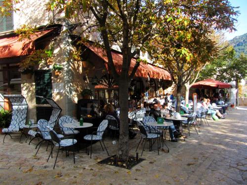 a group of people sitting at tables outside a restaurant at Casa Vell de Valldemossa in Valldemossa
