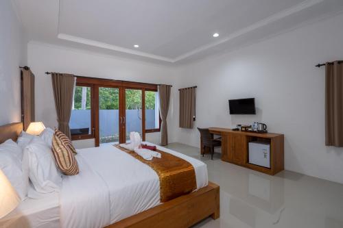 Postel nebo postele na pokoji v ubytování Nusa Indah Onai Hotel