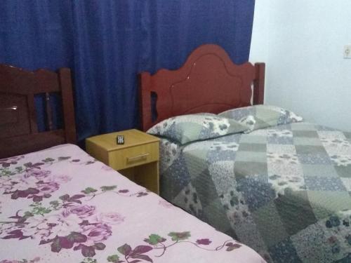 מיטה או מיטות בחדר ב-Hospedagem Carvalho