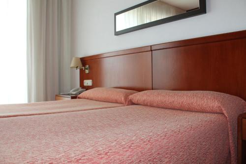 เตียงในห้องที่ Loop INN Hotel Santiago de Compostela