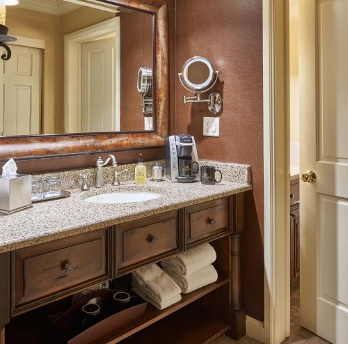 a bathroom with a sink and a mirror at The Wort Hotel in Jackson