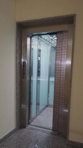 an elevator door with a mirror in a building at Relax Home in La Caletta