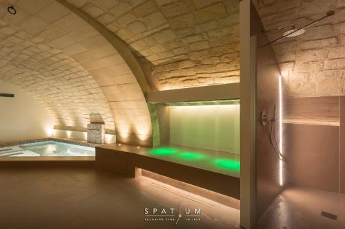 a bathroom with a bath tub in a building at B&B Giardino Di Pietra in Ragusa