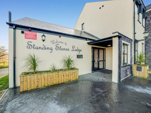 a white building with plants on the side of it at Standing Stones Lodge in Belfast