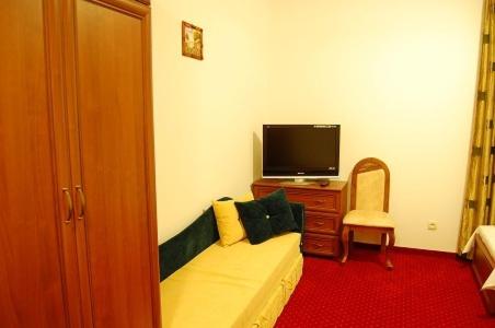 a living room with a couch and a flat screen tv at Pensjonat Korona in Modrzyca
