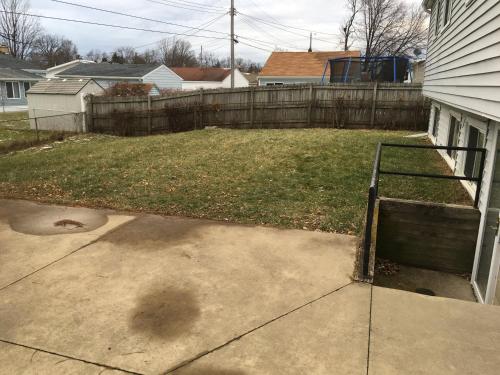 a backyard with a yard with a fence and a yard sidx sidx at The Paradise @ Lyncott in Lansing