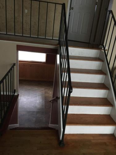a staircase leading up to the basement of a house at The Paradise @ Lyncott in Lansing