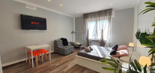 a bedroom with a bed and a tv on the wall at Bsuites Scrovegni in Padova