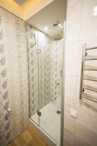 a shower with a glass door in a bathroom at Kyiv Center Smart Apartments in Kyiv