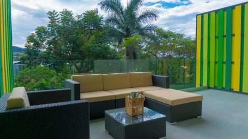 a patio with a couch and a table at BEE Suites Santa Ana in Santa Ana
