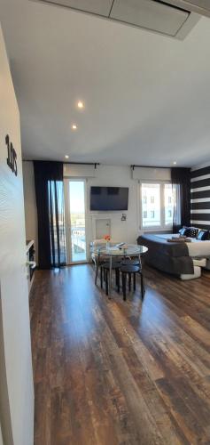 a living room with a table and a couch at Bsuites Scrovegni in Padova
