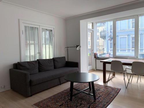 un soggiorno con divano e tavolo di ApartmentInCopenhagen Apartment 1423 a Copenaghen