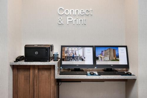 a desk with two computer monitors and a printer at Fairfield Inn & Suites by Marriott Crestview in Crestview