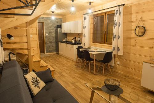 a living room with a couch and a table at Domki pod Skocznią in Zakopane