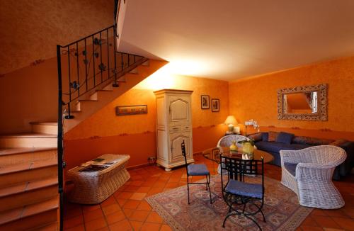 a living room with a blue couch and a staircase at Château d'Adomenil in Rehainviller